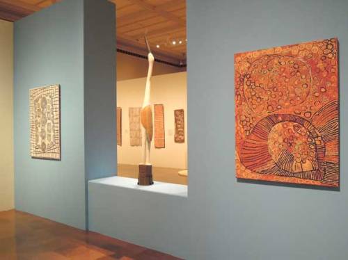 Installation image of Crossing Cultures at the Toledo Museum of Art, showing Patrick Tjungarrayi’s Illyatjara 2001 (left) and Naata Nungurrayi’s Marapinti 2005 (right).